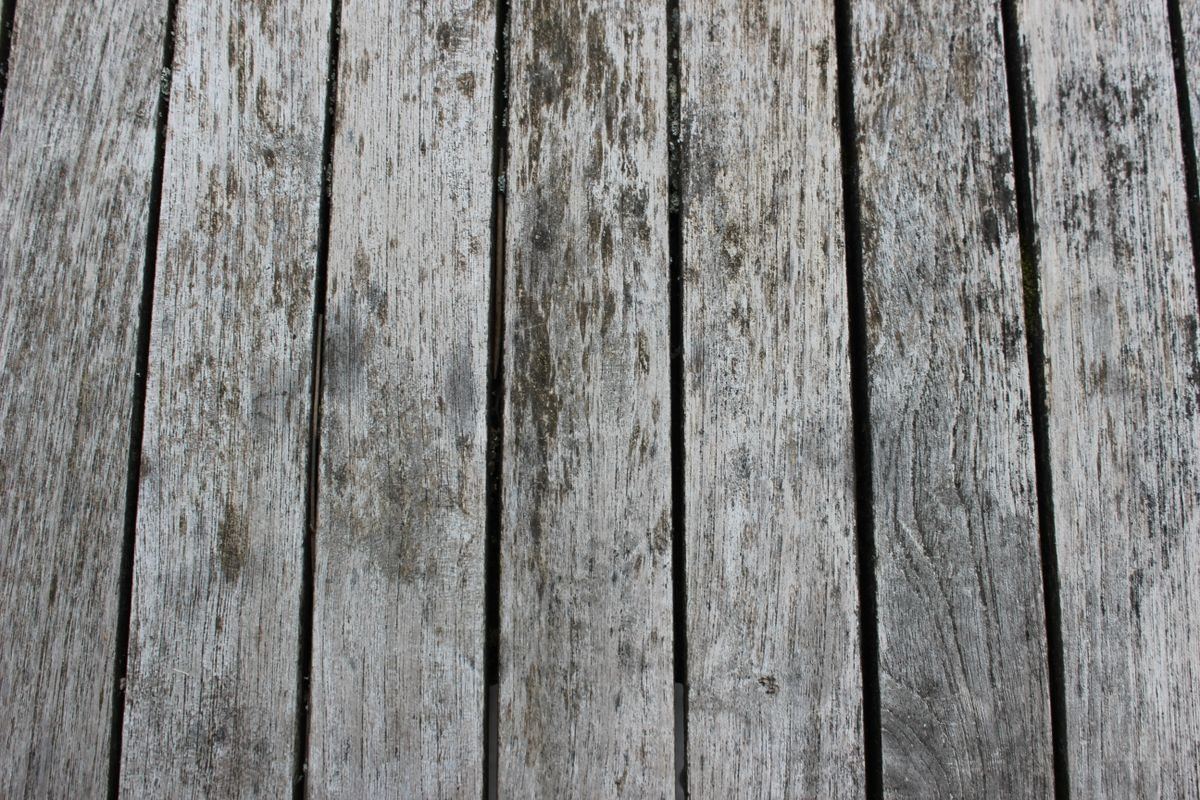 Lames de terrasse en bois grisées, fendues et fibreuses, à diagnostiquer avant rénovation