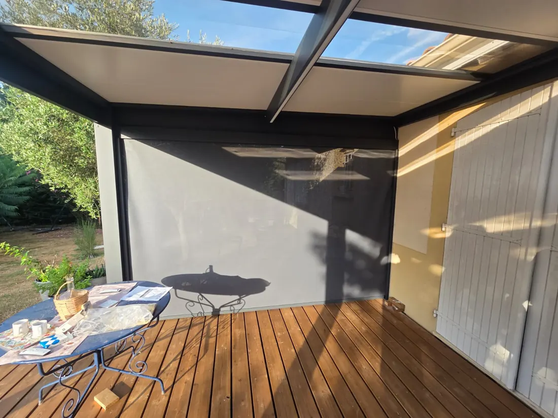 Pergola aluminium anthracite équipée d'un store screen à zip, guidage latéral visible, réalisée par L'Esprit Bois